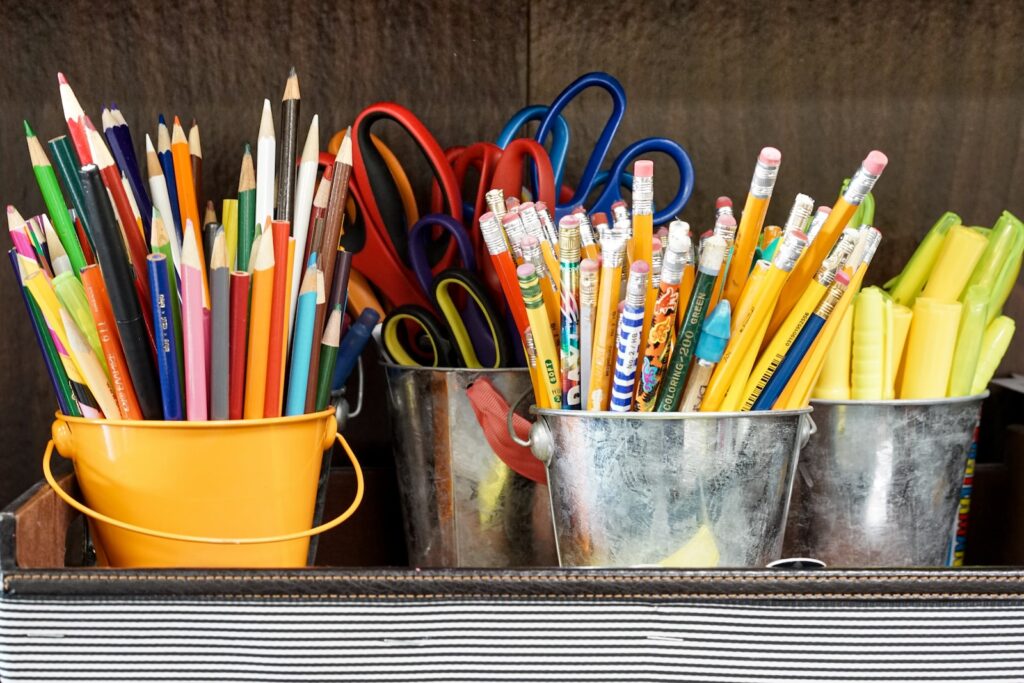 school supplies in buckets showing items that are helpful homeschooling resources